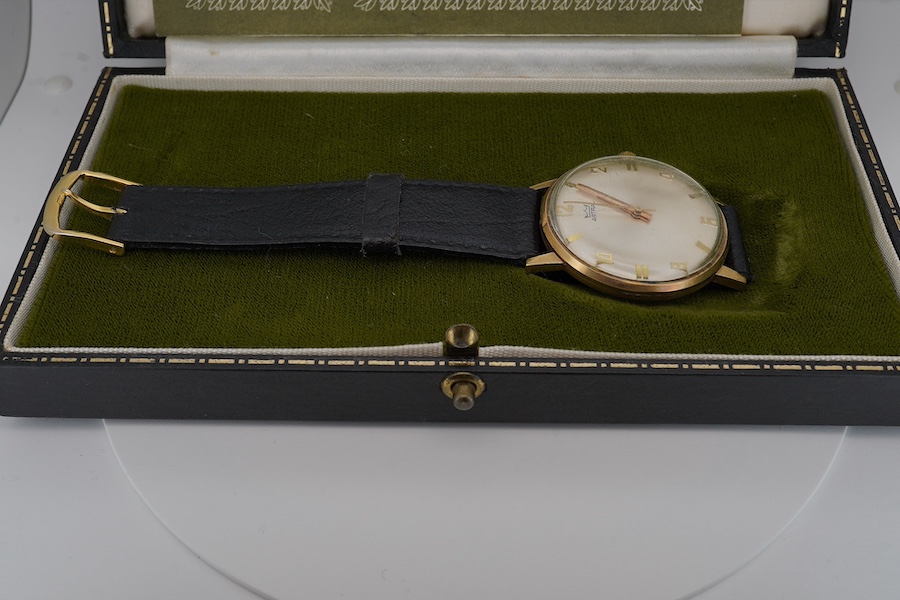 A gentleman's yellow metal Astral manual wind wrist watch, with engraved case back inscription, on a leather strap, with original box and guarantee. Condition - poor to fair